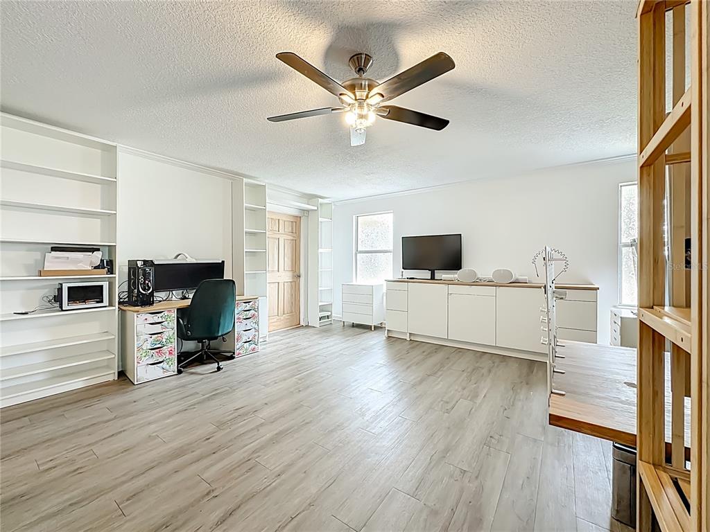 6380 Bahaia Road Fleming Island, FL 32003 - Photo 38 of 77 a living room with furniture and a flat screen tv