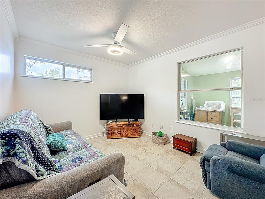 6380 Bahaia Road Fleming Island, FL 32003 - Photo 49 of 77 a living room with furniture and a flat screen tv
