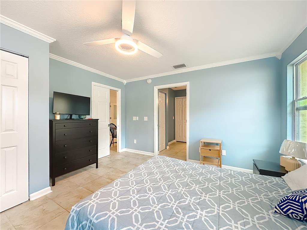 6380 Bahaia Road Fleming Island, FL 32003 - Photo 53 of 77 a bedroom with a bed and a flat screen tv