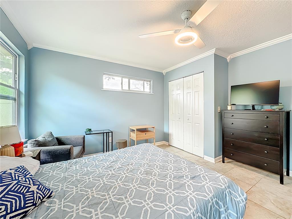 6380 Bahaia Road Fleming Island, FL 32003 - Photo 54 of 77 a bedroom with a bed and wooden floor