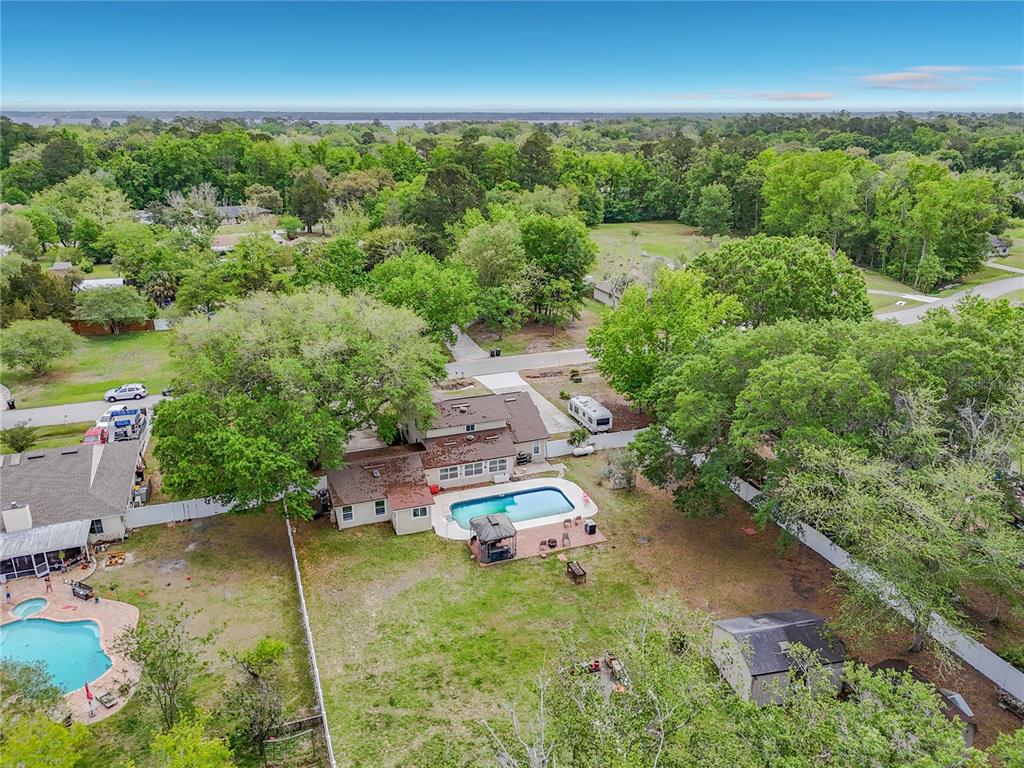 6380 Bahaia Road Fleming Island, FL 32003 - Photo 58 of 77 an aerial view of a house with yard swimming pool and outdoor seating