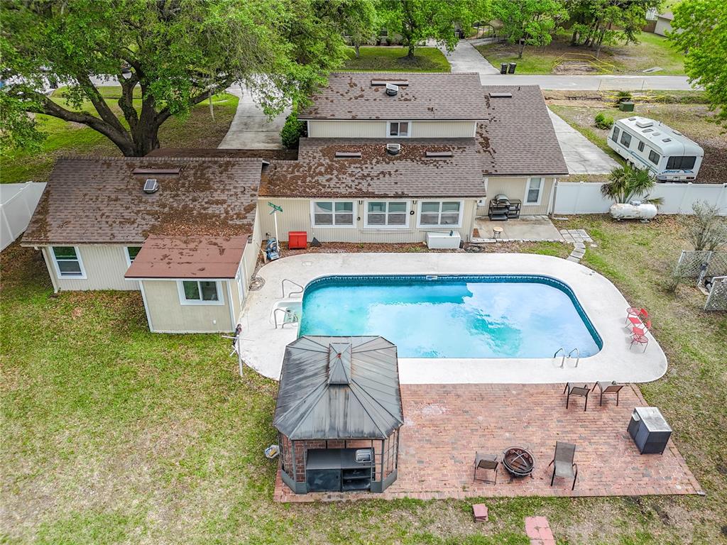6380 Bahaia Road Fleming Island, FL 32003 - Photo 61 of 77 an aerial view of a house with garden space and a swimming pool