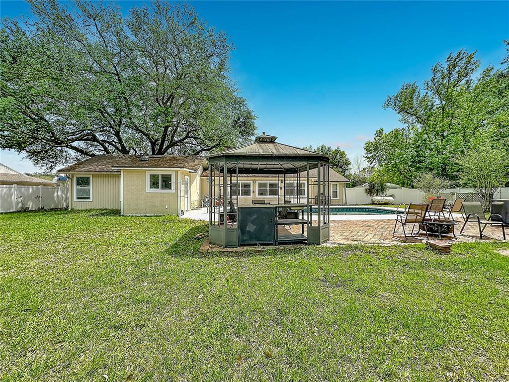 6380 Bahaia Road Fleming Island, FL 32003 - Photo 69 of 77 a view of a house with backyard sitting area and garden
