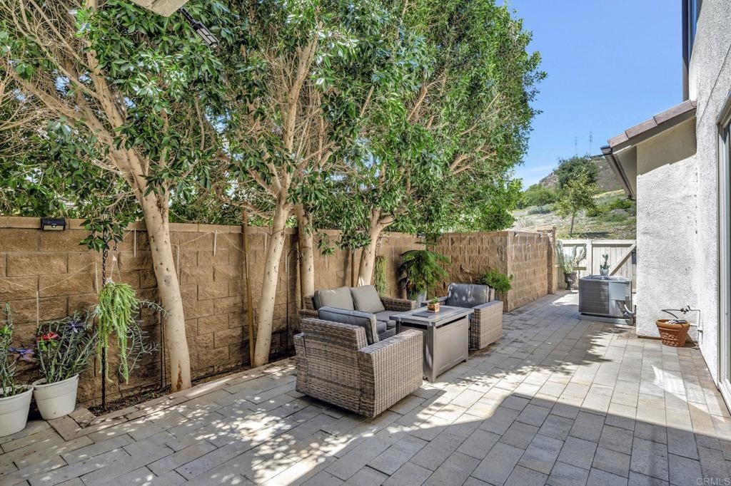 21408 Trail Ridge Drive Escondido, CA 92029 - Photo 33 of 50 a view of a patio with table and chairs potted plants and a large tree