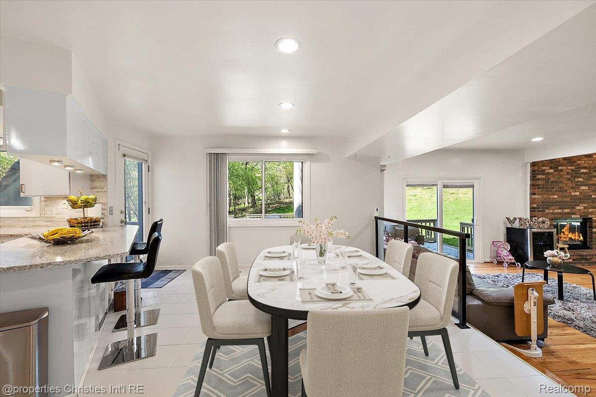 1830 Lone Pine Road Bloomfield Hills, MI 48302 - Photo 10 of 49 Dining area featuring recessed lighting, a fireplace, and light tile patterned floors