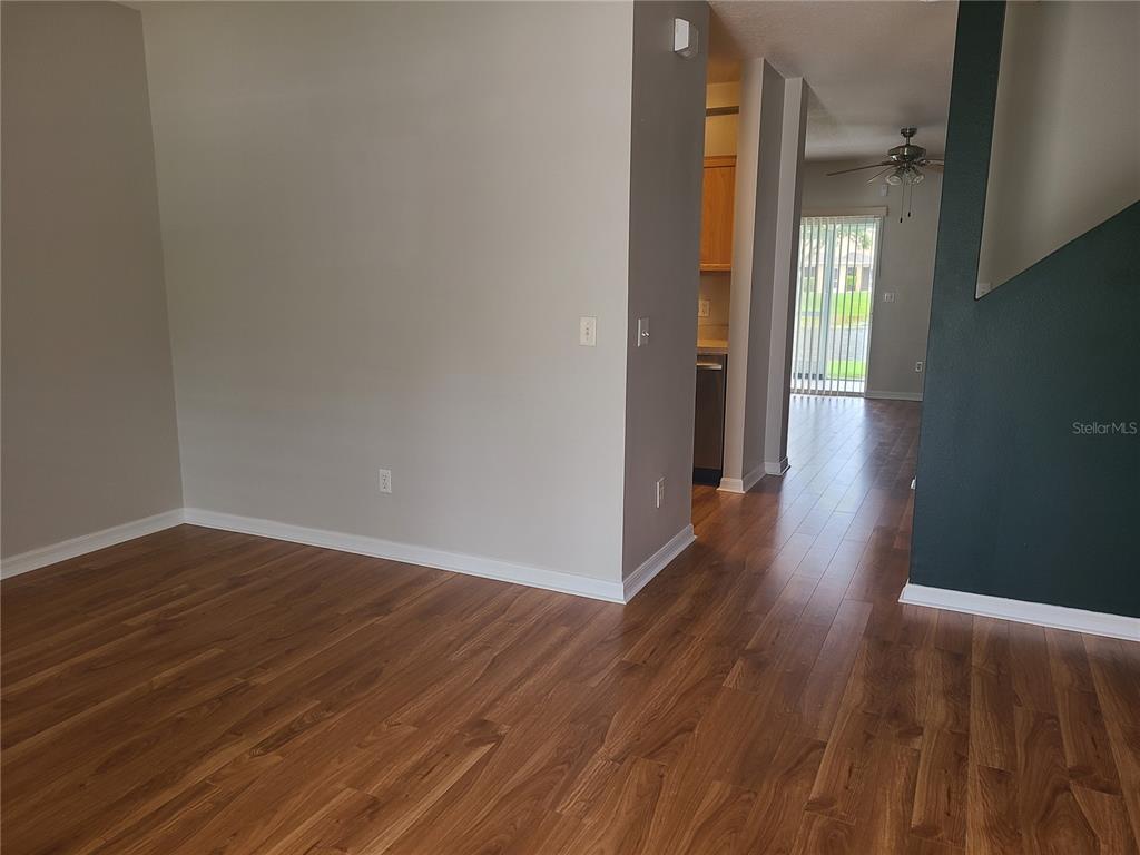 14956 Amberjack Terrace, Unit 103 Lakewood Ranch, FL 34202 - Photo 5 of 16 a view of an empty room with wooden floor and a window