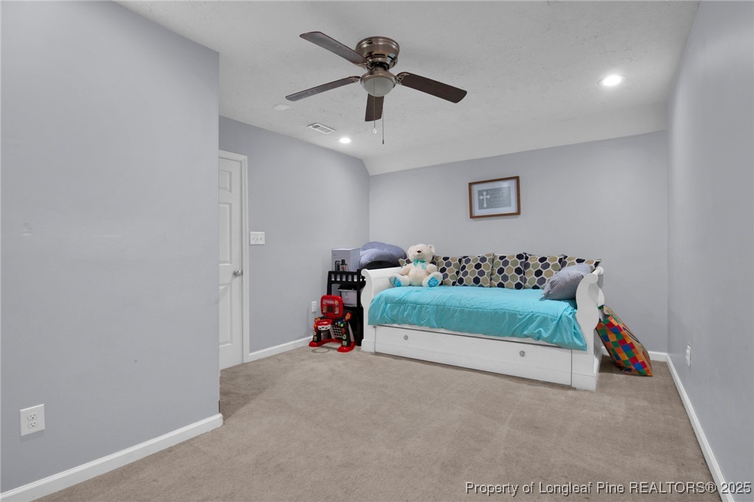 5650 Murphy Road Stedman, NC 28391 - Photo 22 of 36 a bedroom with bed and a chandelier fan