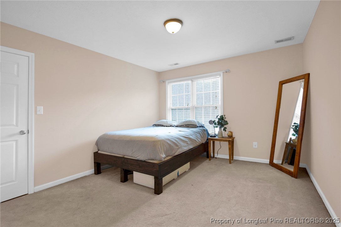 5650 Murphy Road Stedman, NC 28391 - Photo 24 of 36 a bed sitting in a room next to a window