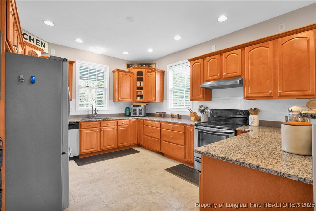 5650 Murphy Road Stedman, NC 28391 - Photo 8 of 36 a kitchen with stainless steel appliances granite countertop a stove a sink dishwasher a refrigerator and a microwave