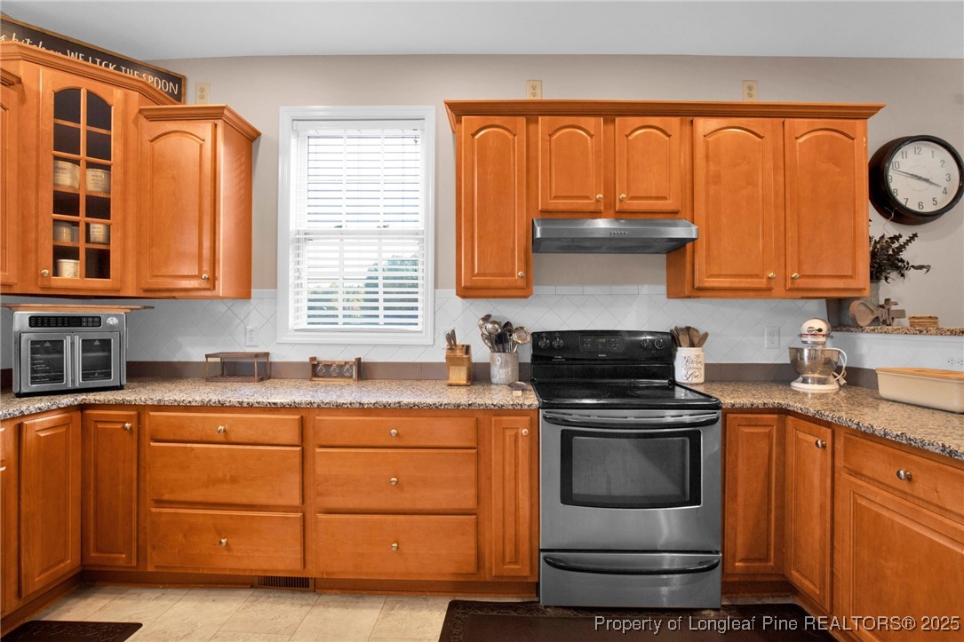5650 Murphy Road Stedman, NC 28391 - Photo 9 of 36 a kitchen with stainless steel appliances granite countertop a stove and a sink