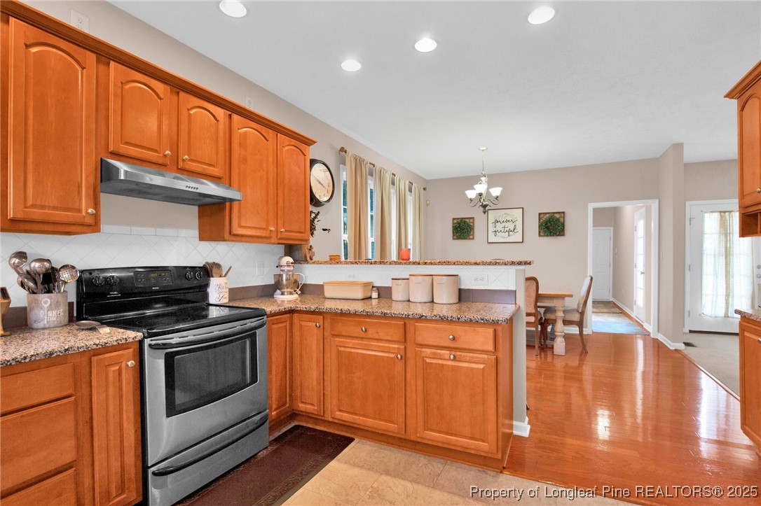 5650 Murphy Road Stedman, NC 28391 - Photo 10 of 36 a kitchen with a stove a sink and cabinets