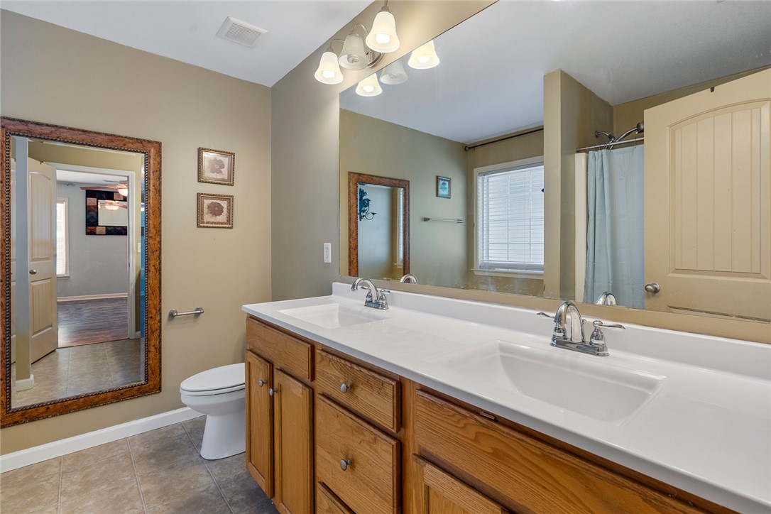 167 Mediterranean Avenue Anderson, SC 29621 - Photo 20 of 33 Ample counter space and dual sinks highlight this well-appointed bathroom, featuring tile flooring and a functional vanity.
