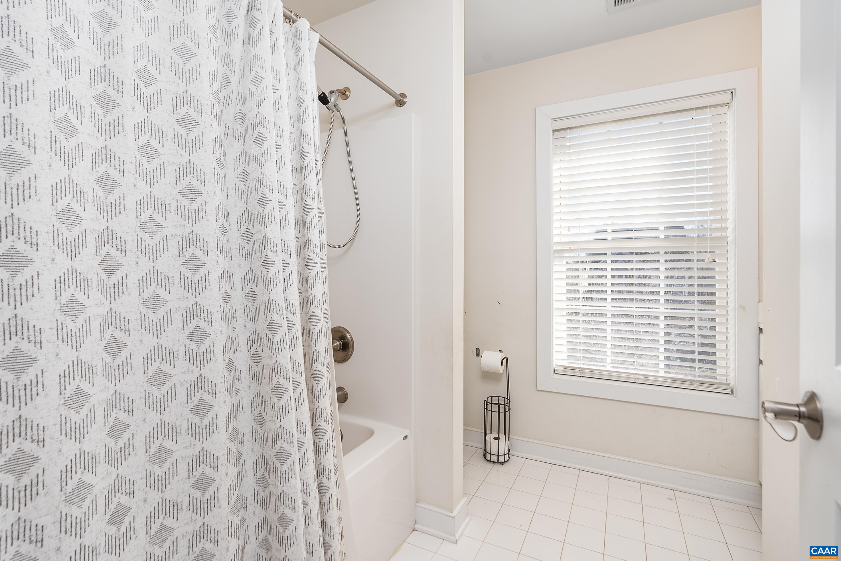 5478 Park Road Crozet, VA 22932 - Photo 15 of 24 a bathroom with a shower curtain and a window