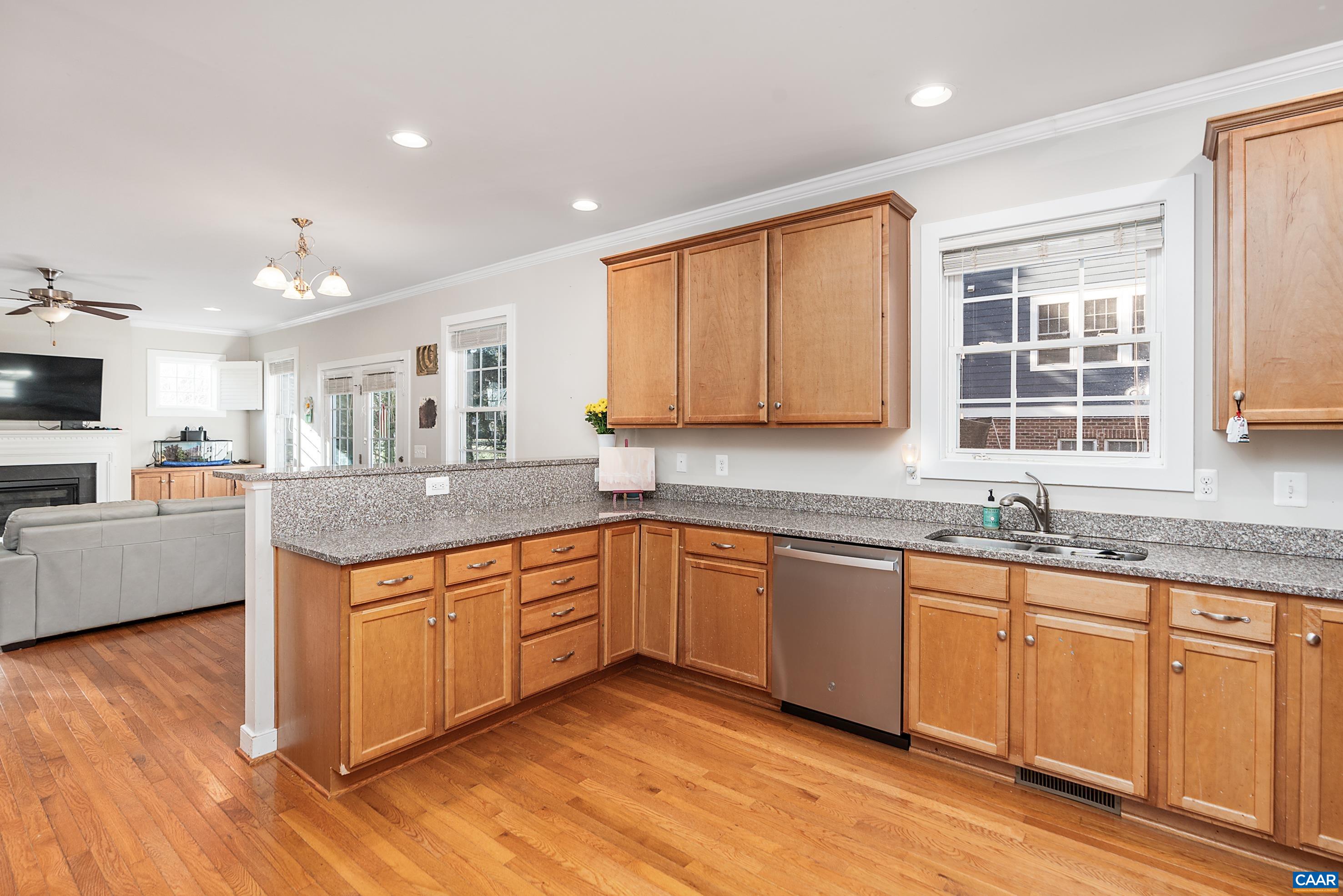 5478 Park Road Crozet, VA 22932 - Photo 6 of 24 a kitchen with granite countertop wooden cabinets a sink dishwasher and a stove with wooden floor