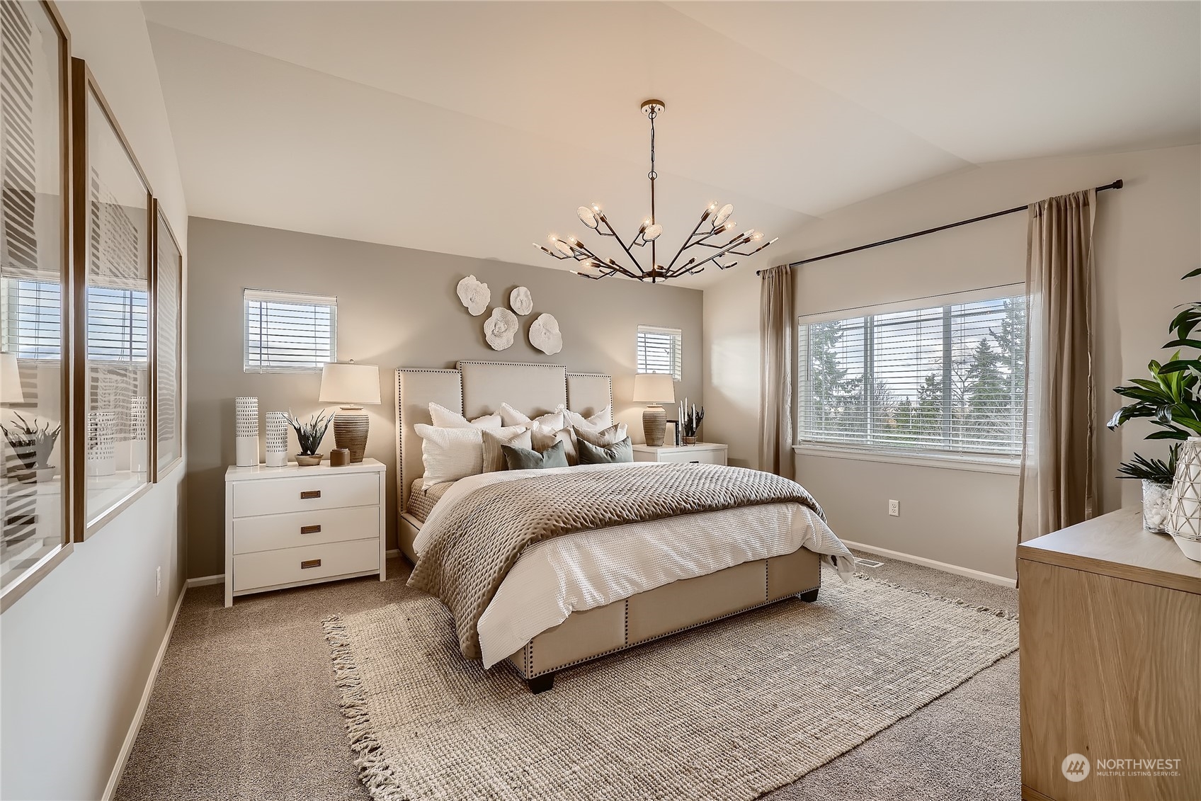 21120 42nd Drive Southeast, Unit 124 Bothell, WA 98021 - Photo 15 of 23 a spacious bedroom with a large bed and a chandelier