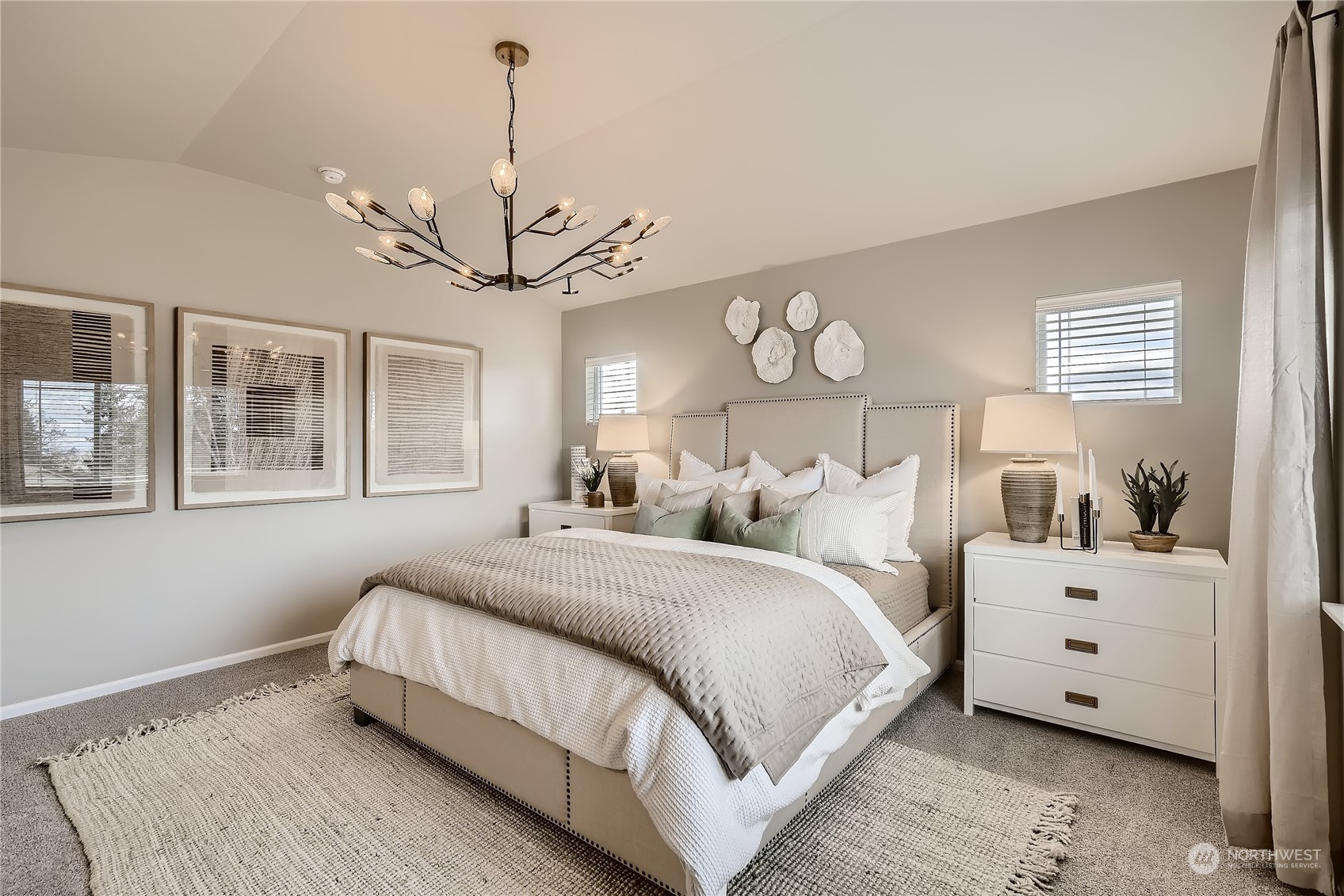 21120 42nd Drive Southeast, Unit 124 Bothell, WA 98021 - Photo 17 of 23 a spacious bedroom with a bed and a chandelier