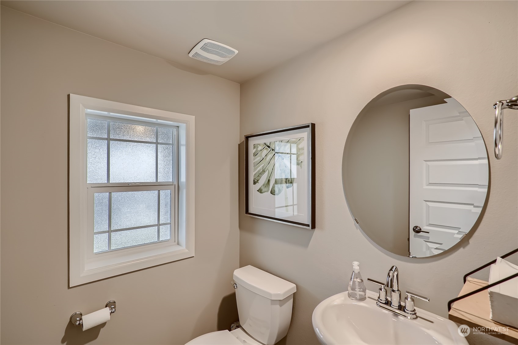 21120 42nd Drive Southeast, Unit 124 Bothell, WA 98021 - Photo 22 of 23 a bathroom with a toilet a sink and mirror