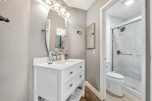 a spacious bathroom with a toilet sink and shower