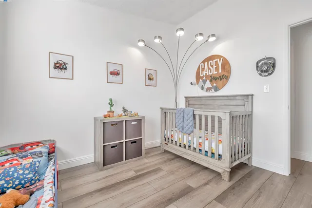 a bedroom with furniture and a baby crib