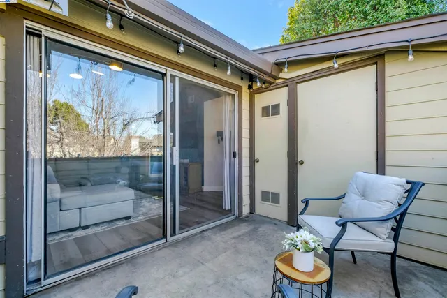 a view of outdoor room and dining room with a glass door