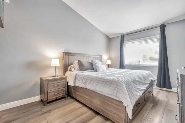 a bedroom with a bed and a large window