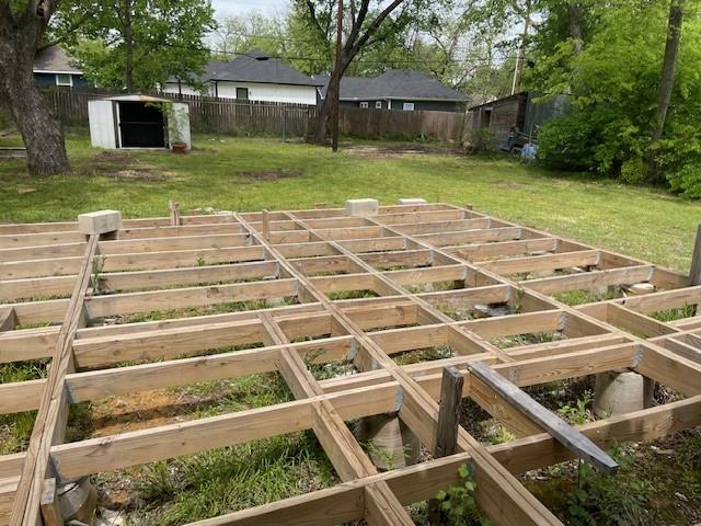 515 East Murray Street Denison, TX 75021 - Photo 13 of 22 Fenced backyard featuring a shed