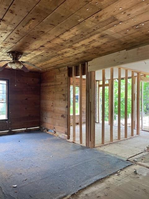 515 East Murray Street Denison, TX 75021 - Photo 10 of 22 Unfurnished room featuring wood ceiling, ceiling fan, and wood walls