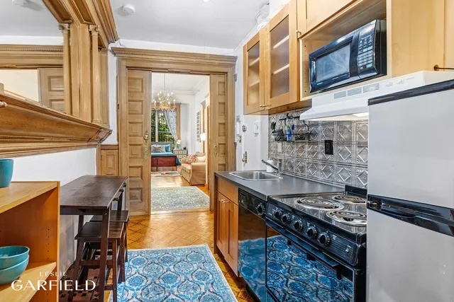 a kitchen with stainless steel appliances granite countertop a stove and a wooden cabinets