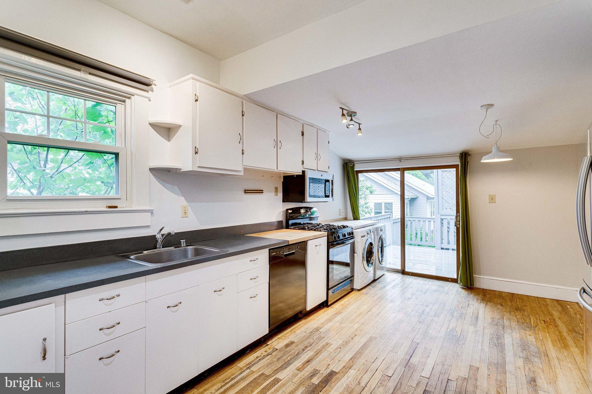 721 Boundary Avenue Silver Spring, MD 20910 - Photo 6 of 17 Open kitchen with hardwood floors and deck access