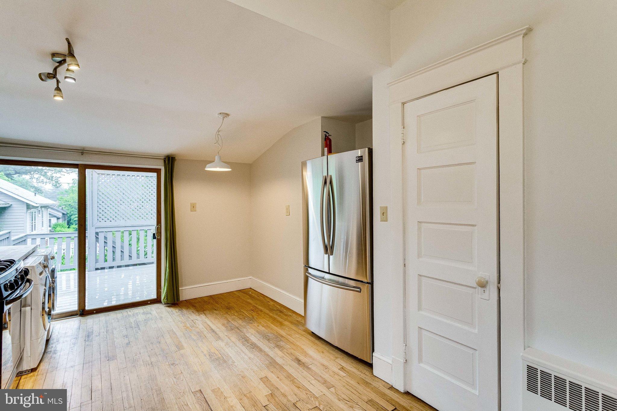 721 Boundary Avenue Silver Spring, MD 20910 - Photo 9 of 17 Open kitchen with hardwood floors and deck access