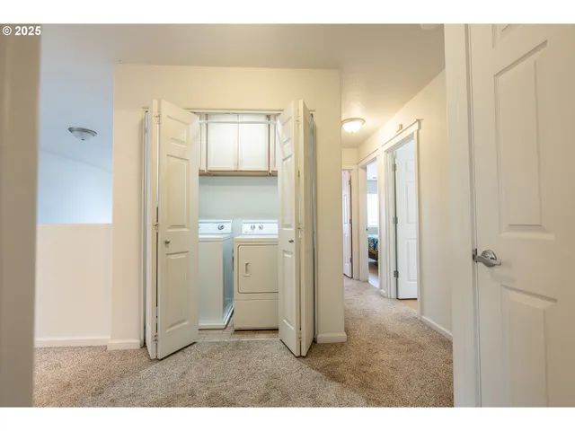a view of a hallway with a kitchen