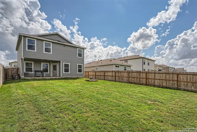 a big house with a big yard and more large tree
