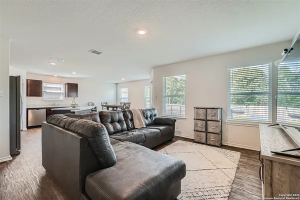 a bedroom with furniture and a flat screen tv