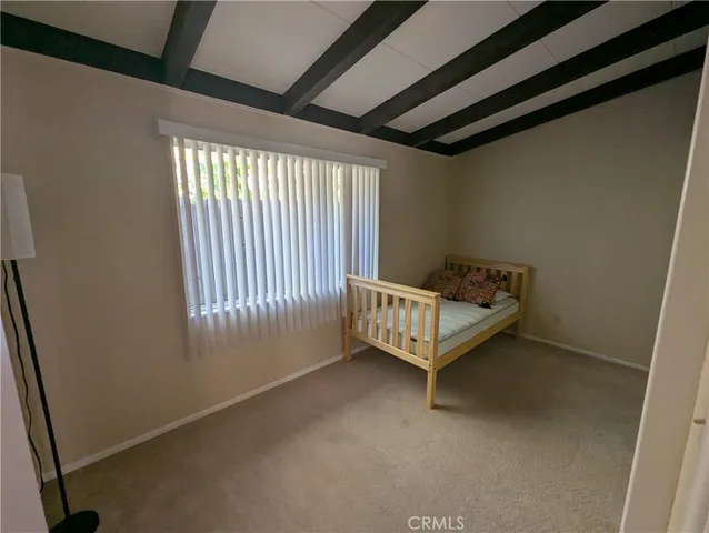 a bed sitting in a room next to a window