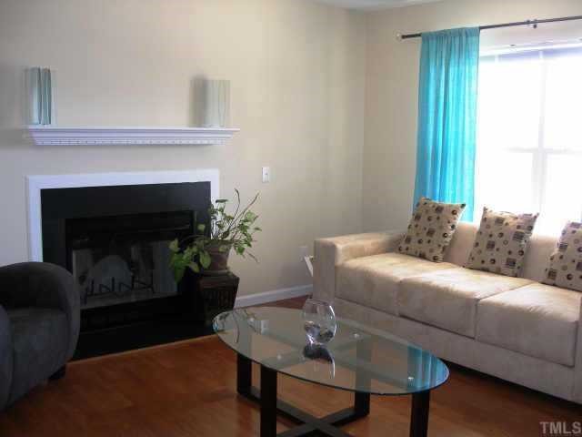 3717 Satinleaf Drive Raleigh, NC 27616 - Photo 3 of 12 a living room with furniture and a fireplace