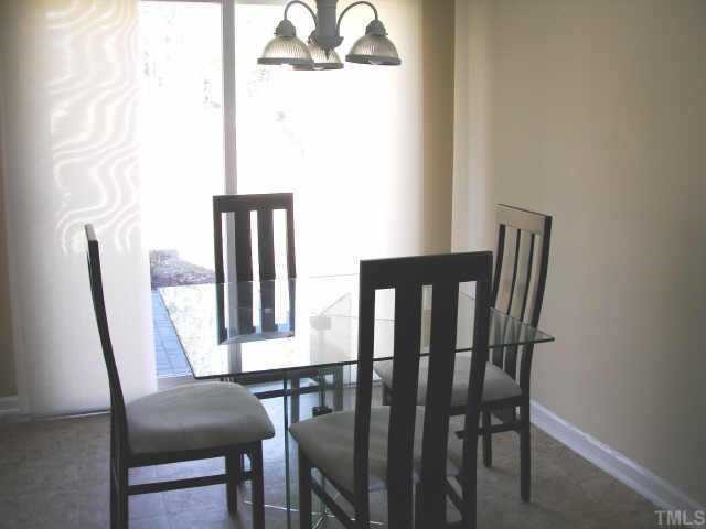 3717 Satinleaf Drive Raleigh, NC 27616 - Photo 4 of 12 a view of a dining room with furniture and a window