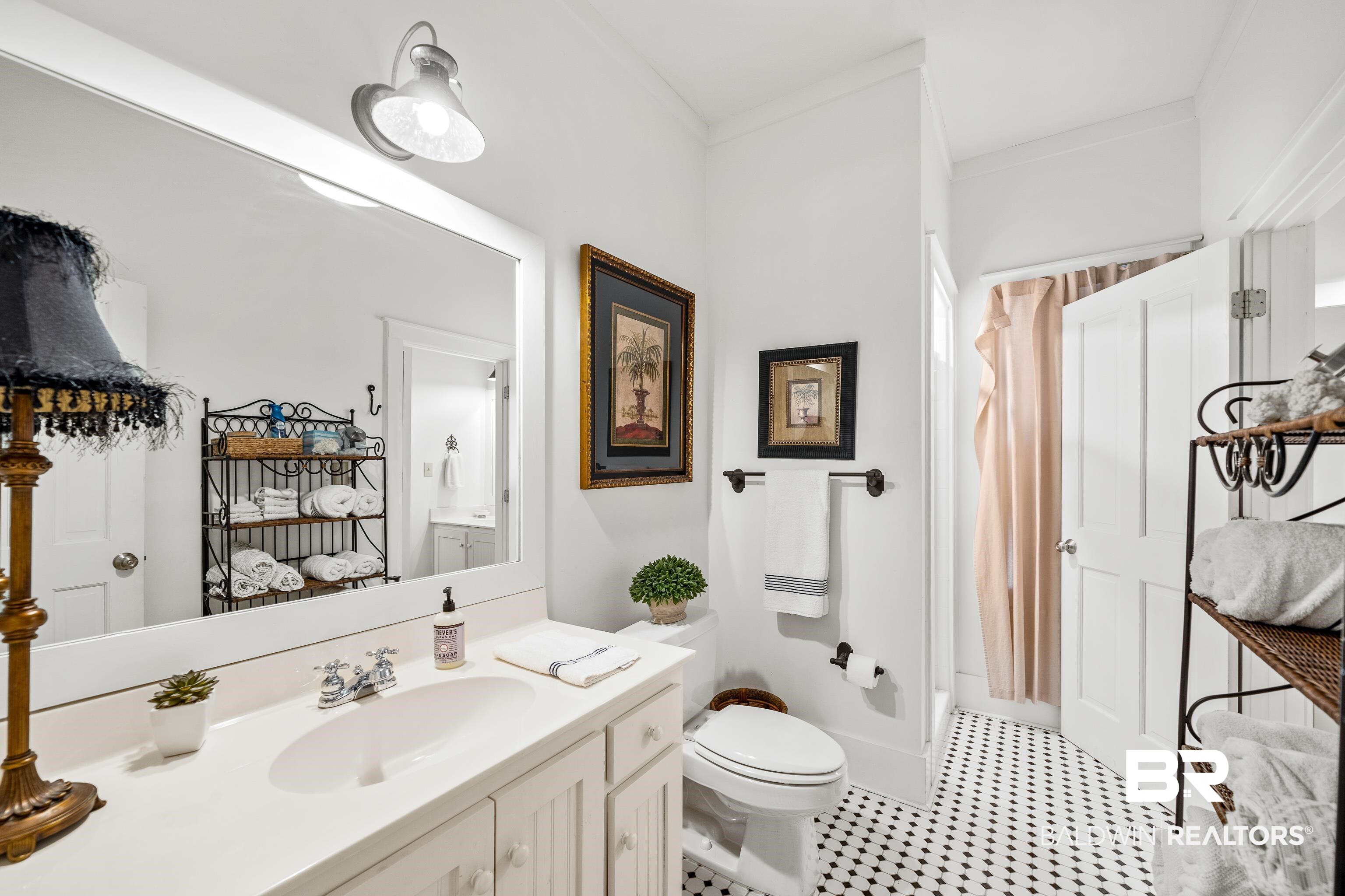 25773 Canal Road, Unit 10 Orange Beach, AL 36561 - Photo 12 of 40 Bathroom featuring vanity, toilet, and crown molding