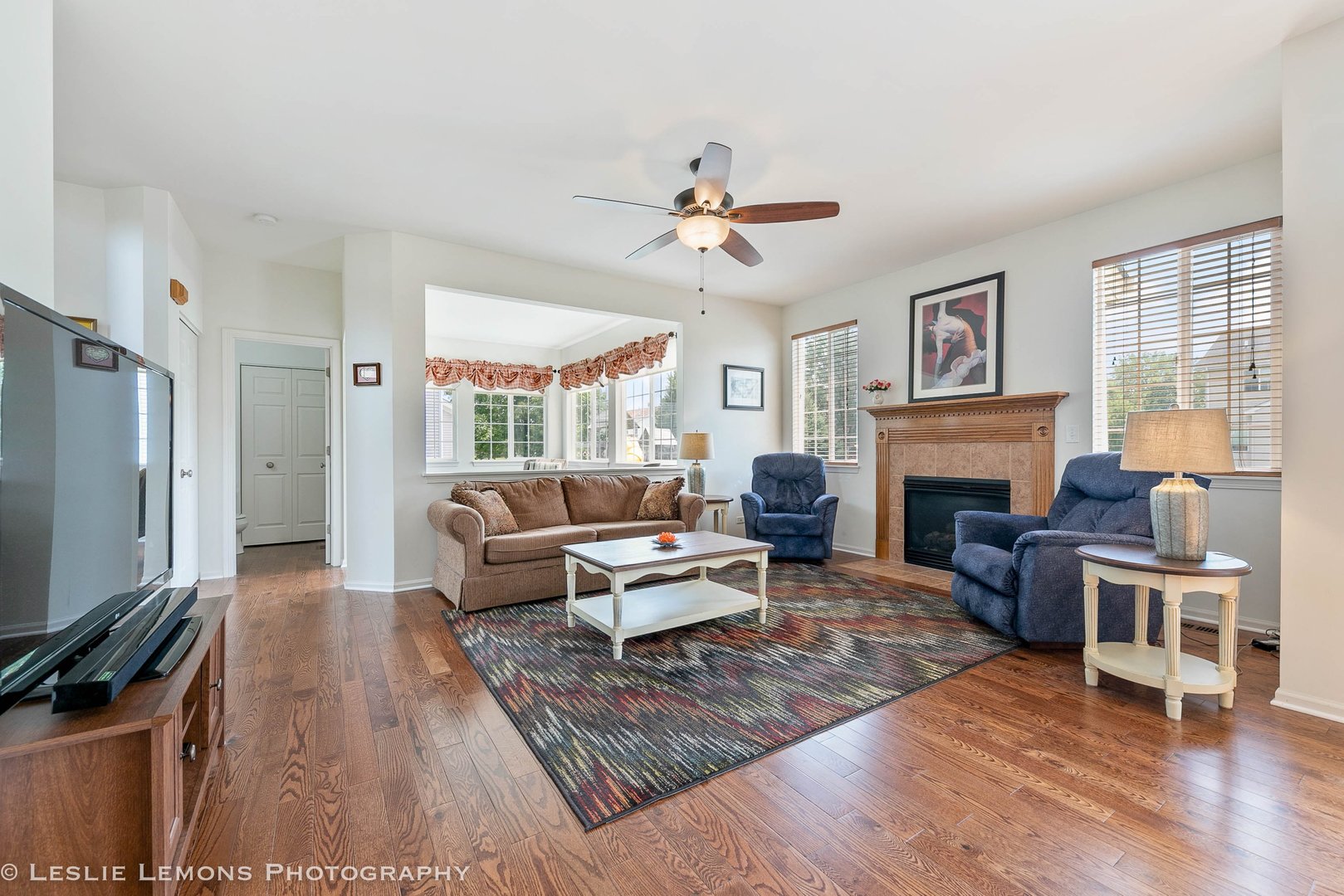 3027 Patterson Road Montgomery, IL 60538 - Photo 12 of 32 a living room with furniture a fireplace and a flat screen tv