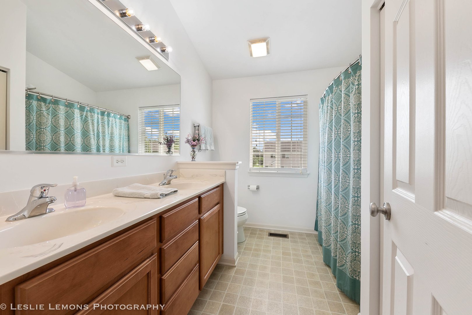 3027 Patterson Road Montgomery, IL 60538 - Photo 22 of 32 a spacious bathroom with a double vanity sink a mirror and a shower