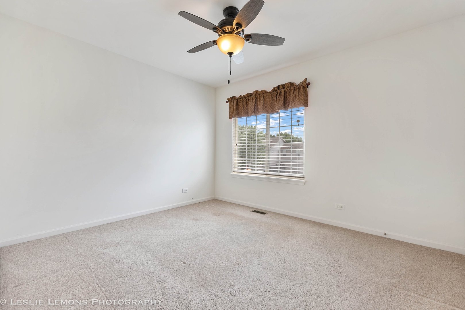 3027 Patterson Road Montgomery, IL 60538 - Photo 26 of 32 a view of an empty room with a ceiling fan and a window