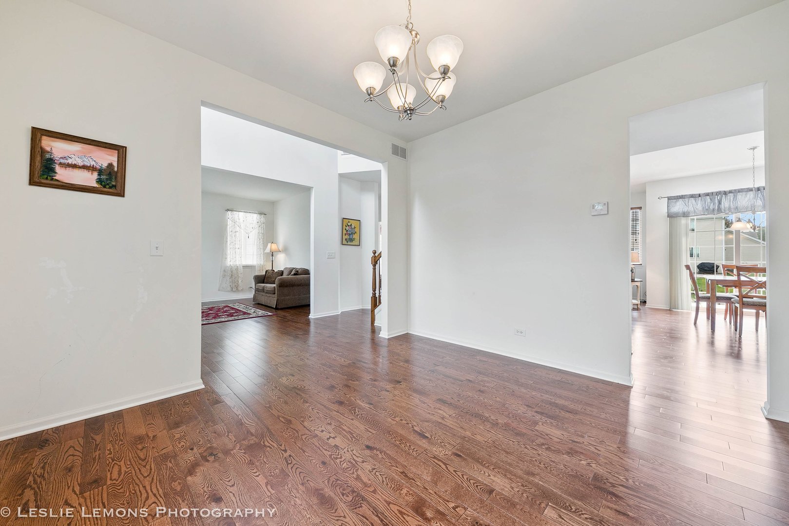 3027 Patterson Road Montgomery, IL 60538 - Photo 6 of 32 a view of a livingroom with wooden floor and a ceiling fan