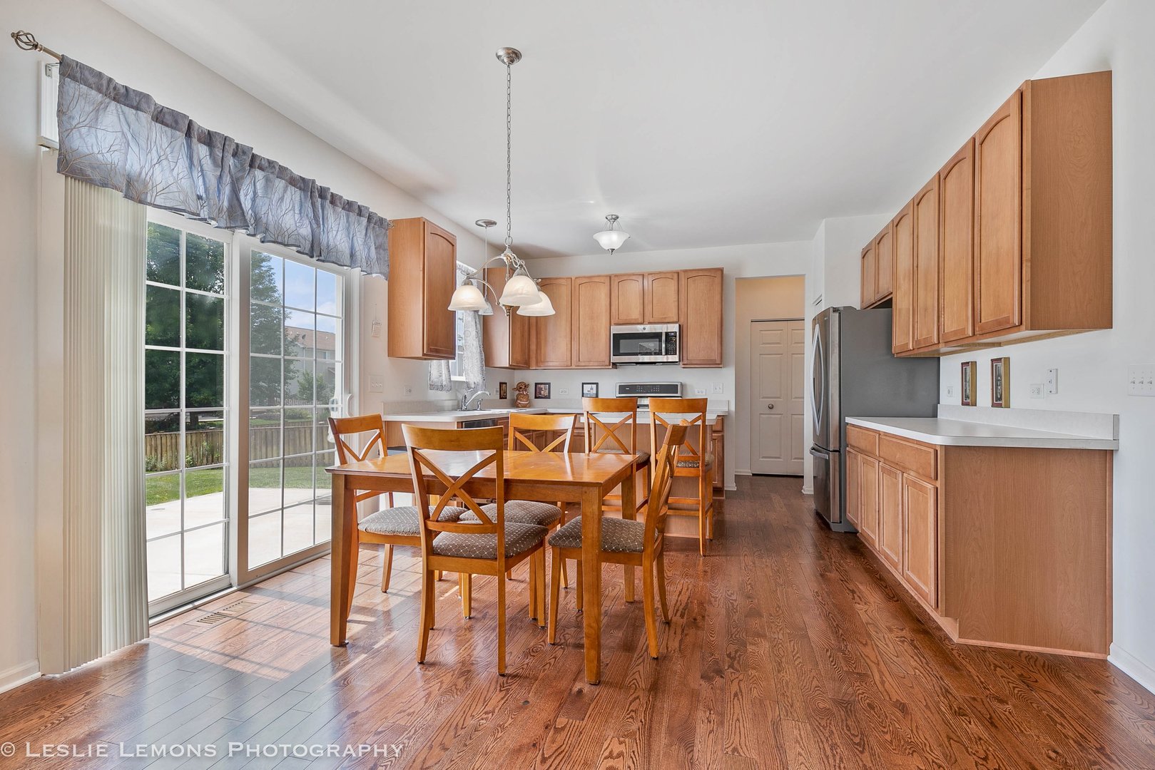 3027 Patterson Road Montgomery, IL 60538 - Photo 7 of 32 a kitchen with stainless steel appliances kitchen island granite countertop a table chairs and a wooden cabinets