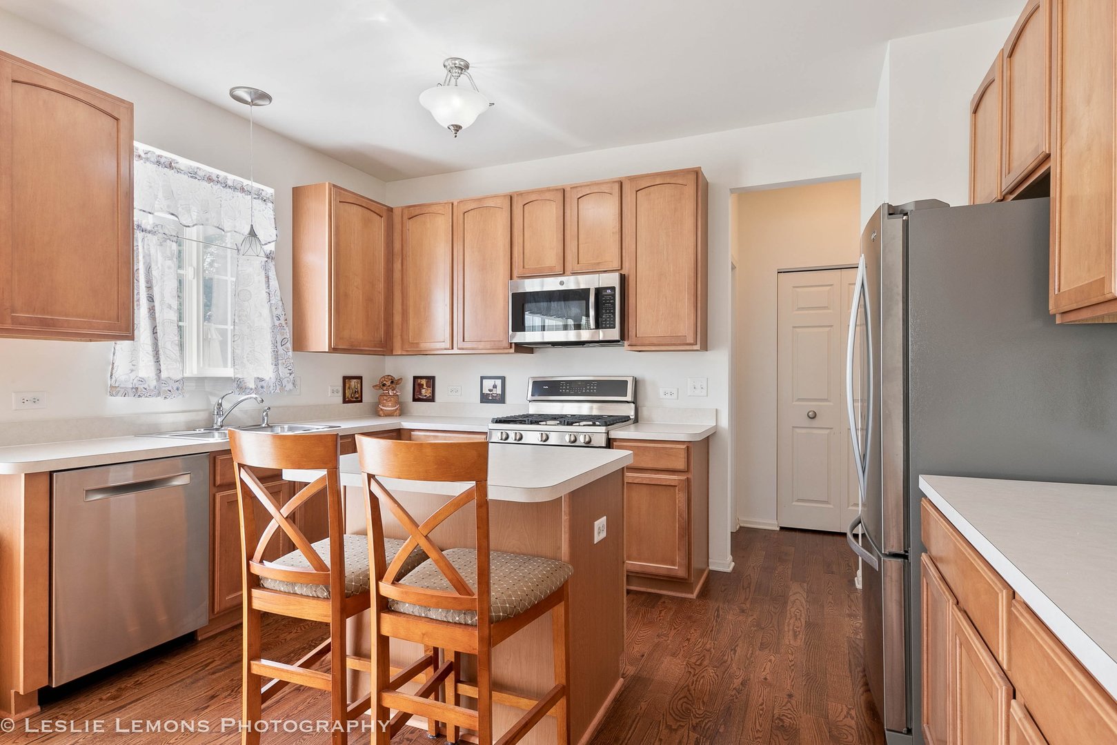 3027 Patterson Road Montgomery, IL 60538 - Photo 8 of 32 a kitchen with stainless steel appliances granite countertop a stove a sink dishwasher a refrigerator and cabinets with wooden floor
