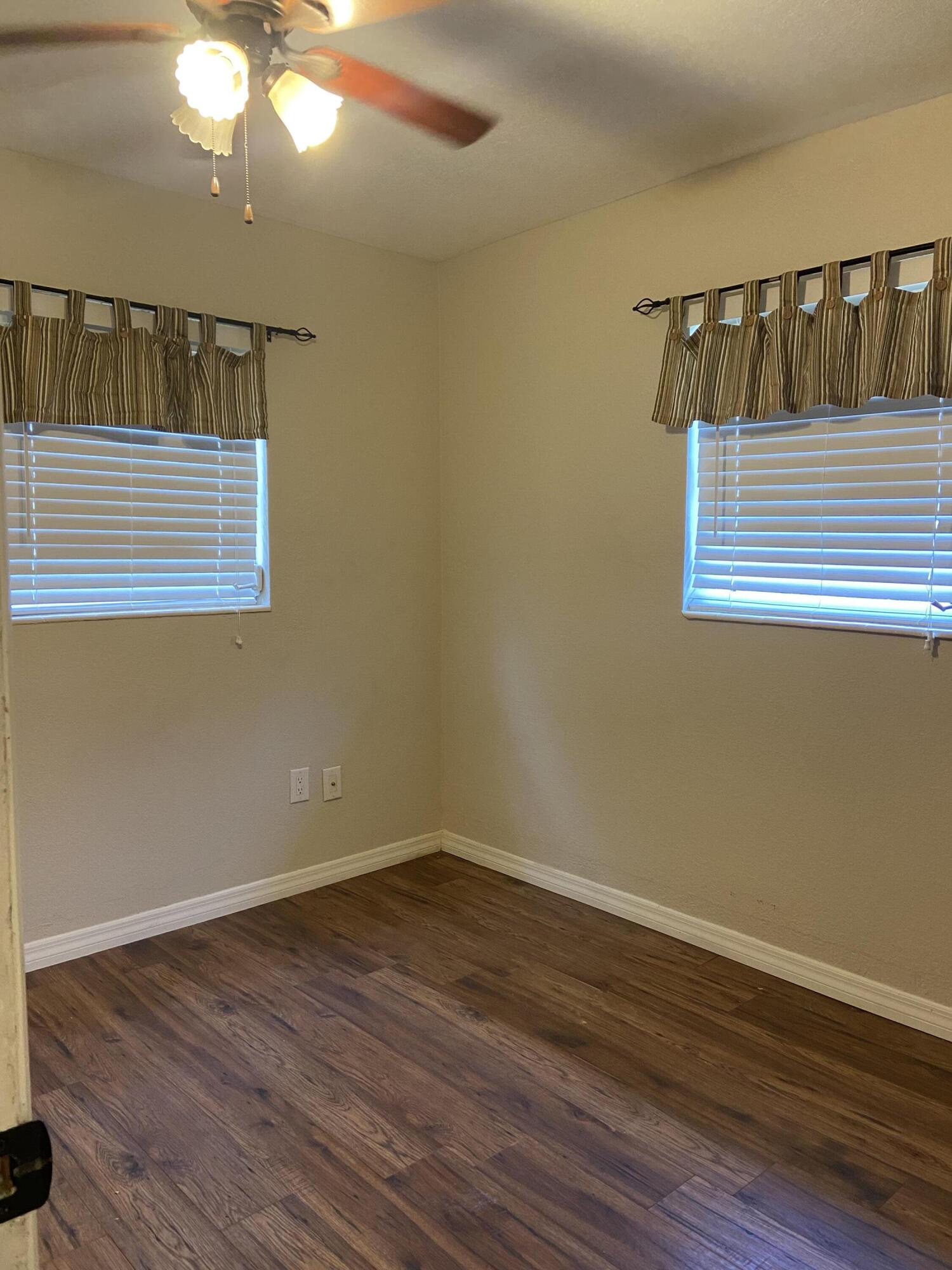 2544 Coventry Road Melbourne, FL 32935 - Photo 11 of 16 a view of hallway with wooden floor and fan