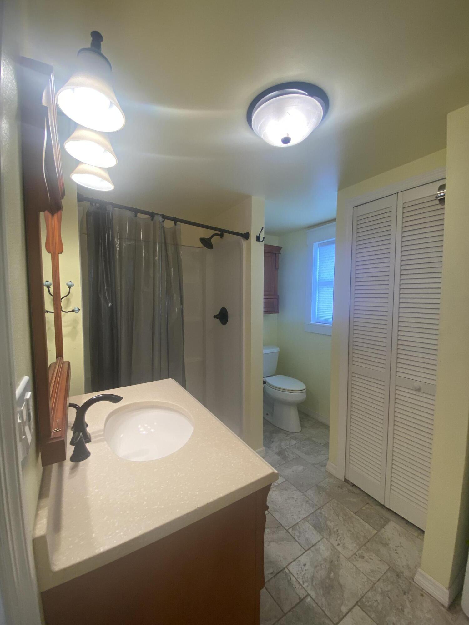 2544 Coventry Road Melbourne, FL 32935 - Photo 9 of 16 a bathroom with a sink toilet and shower
