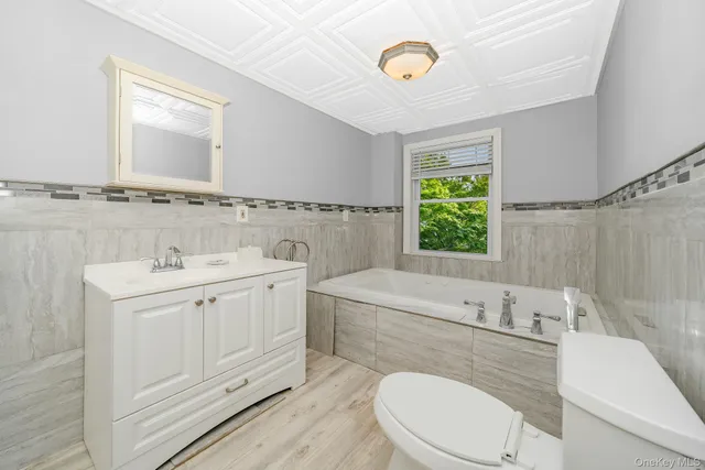 a bathroom with a sink a toilet and tub