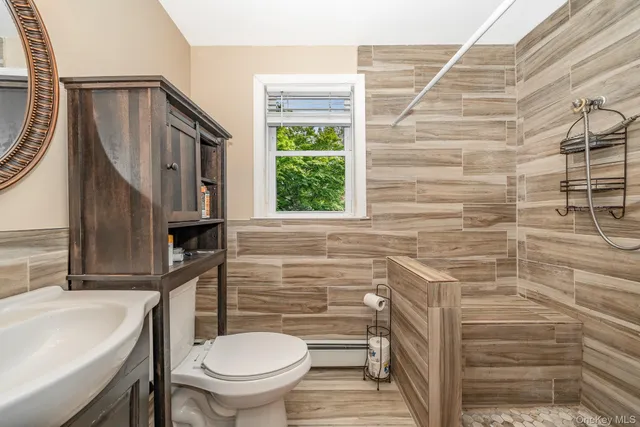 a bathroom with a toilet a sink and a shower