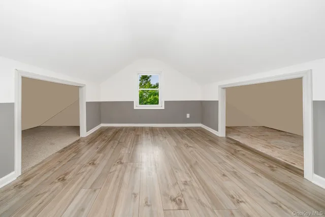 a view of room with window and wooden floor