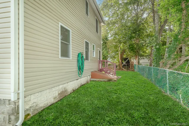 a view of a house with backyard and sitting area