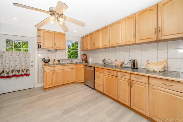 a kitchen with stainless steel appliances granite countertop a sink a cabinets and window